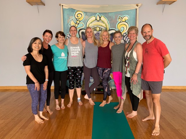 Group photograph of seven participants and two teachers for the "Getting Off the Mat" training module.